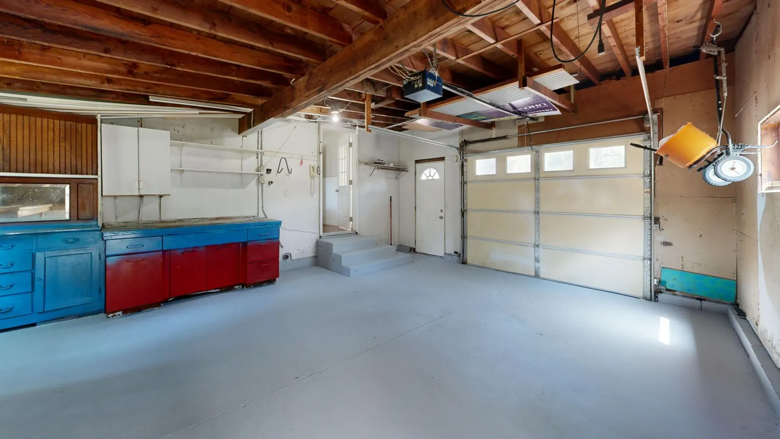 Clean coated garage floor with built-in cabinets in a San Marcos home