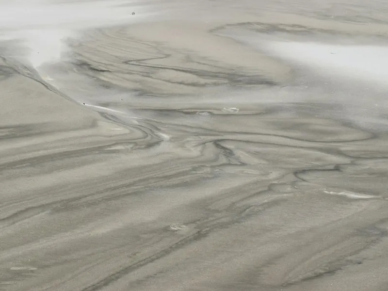 Swirled gray metallic epoxy floor finish with marbled pattern